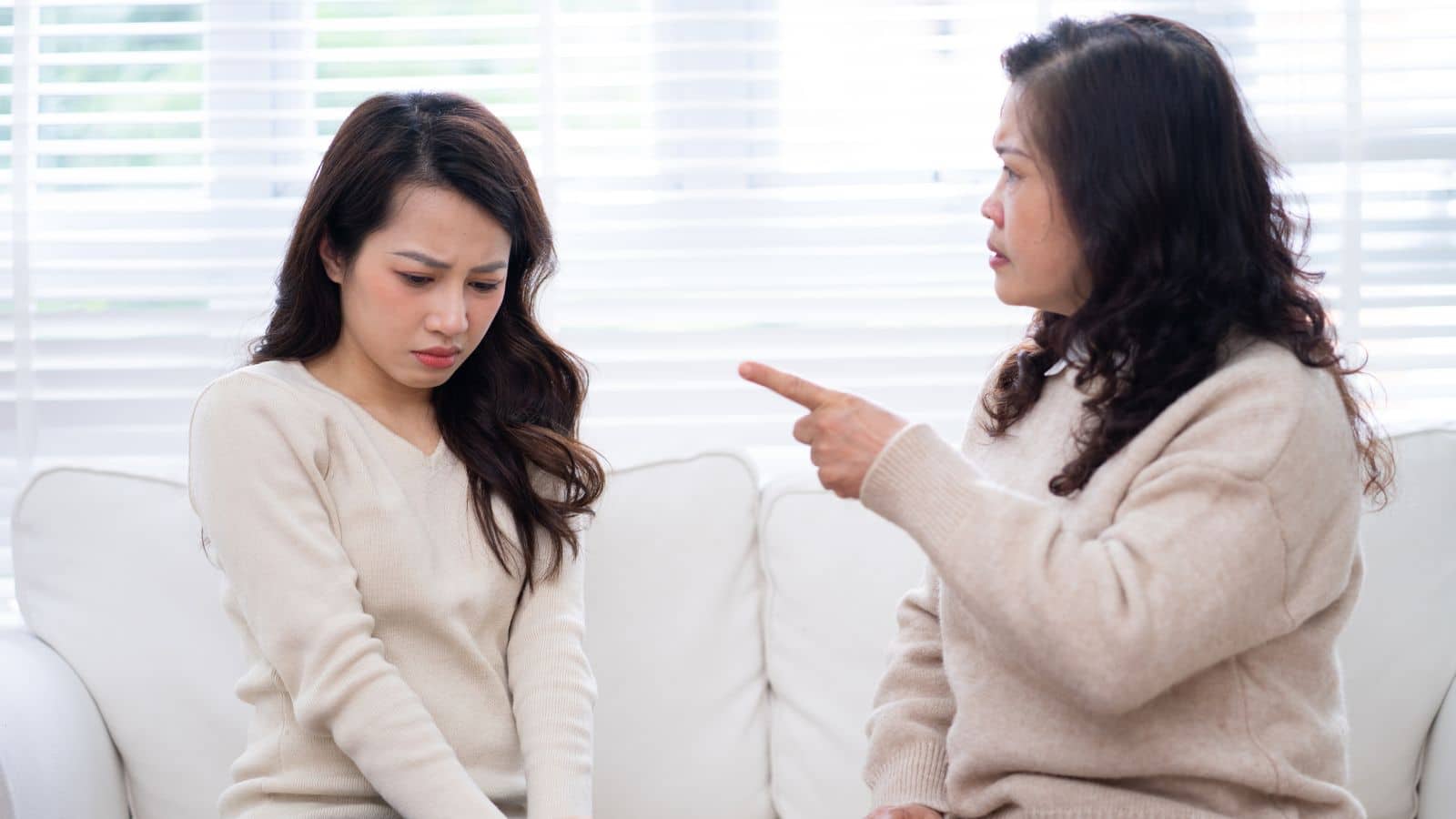 Mother yelling and daughter who looks sad