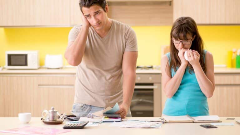 Couple looking upset about their finances