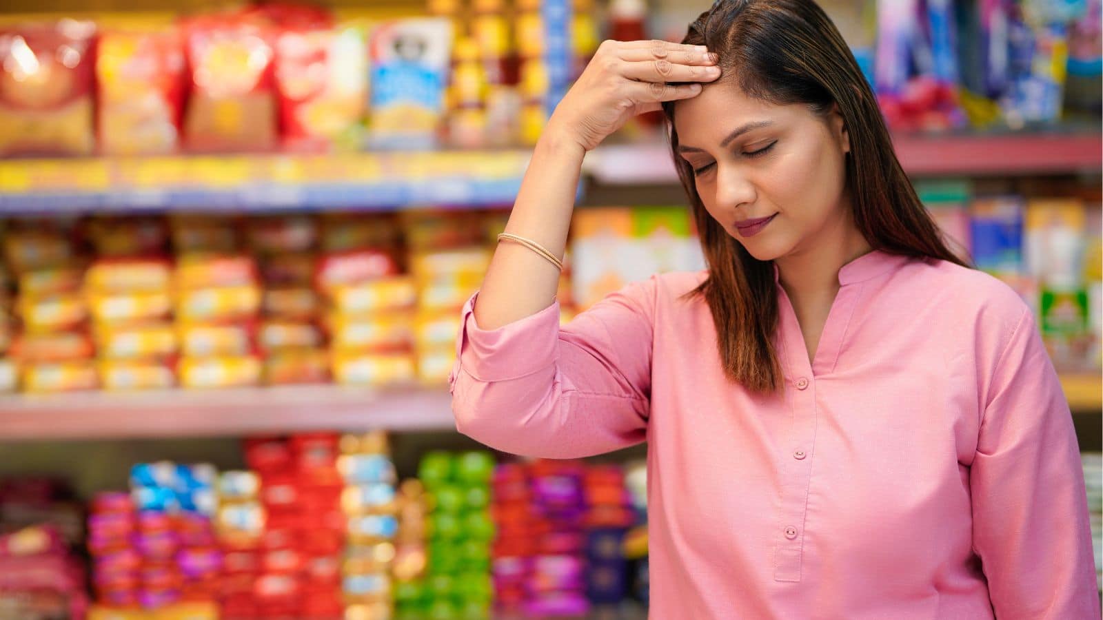 Woman looking upset in a grocery aisle