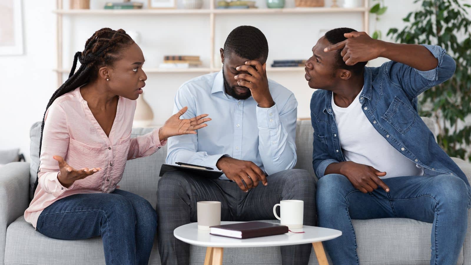 Family sitting on the couch arguing