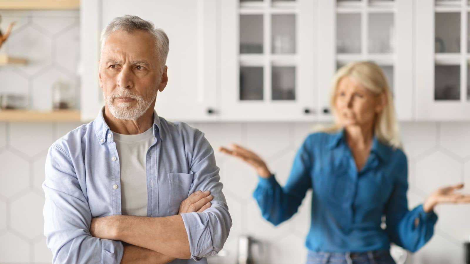Middle-aged couple arguing in the kitchen