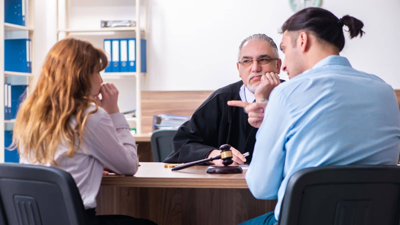 Couple arguing in front of a judge