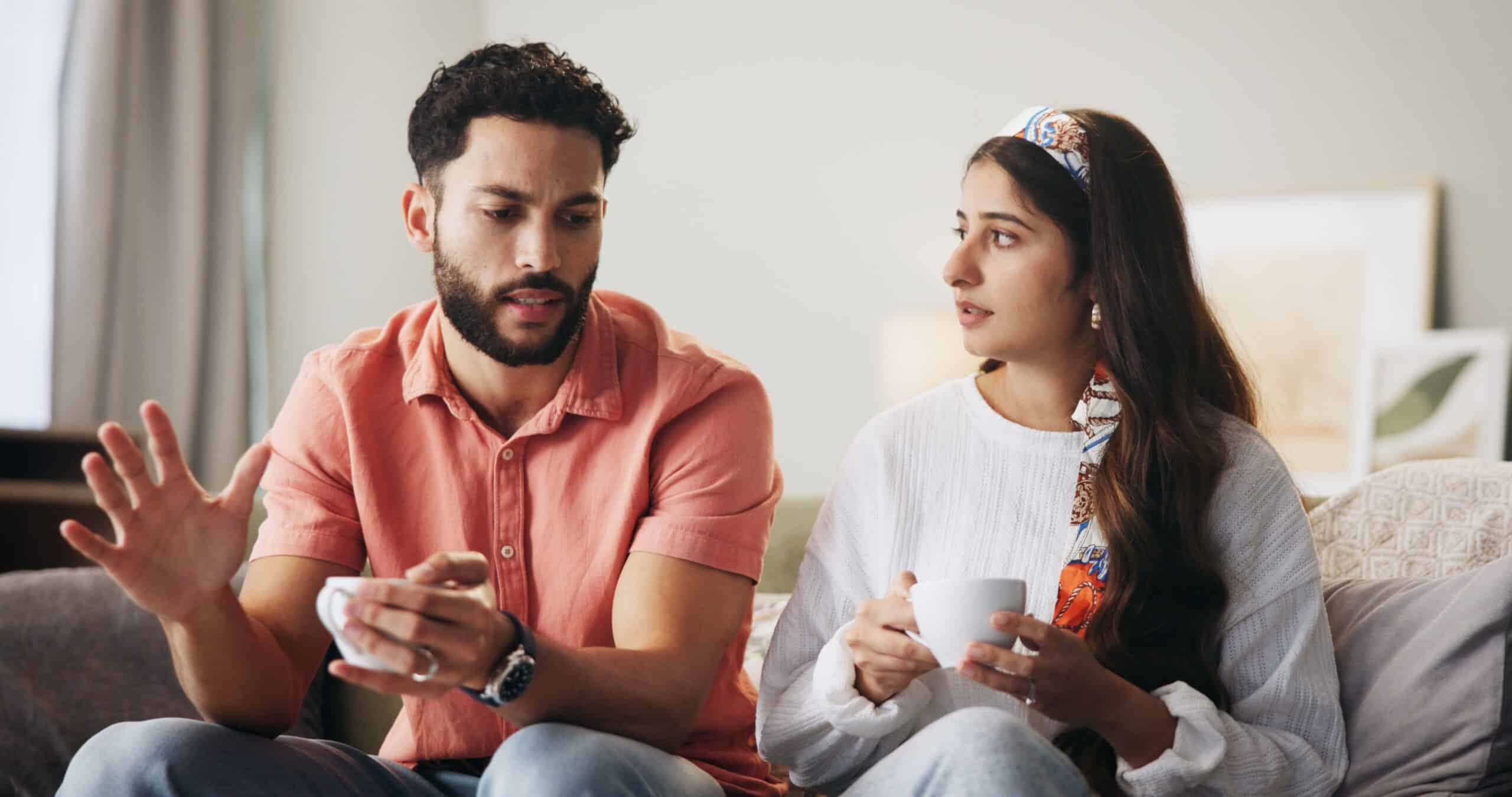 Couple talking on couch