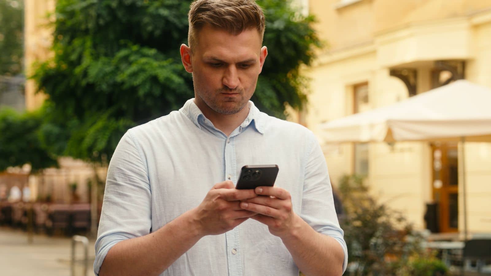 Man looking angrily at his phone