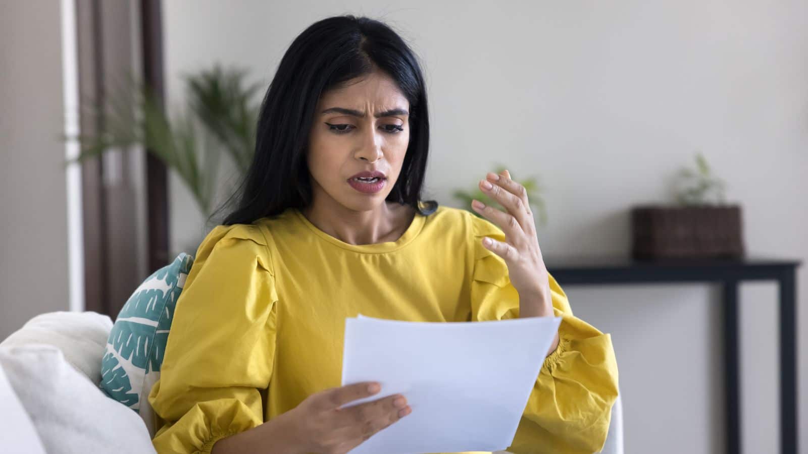 Woman looking upset as she looks at a bill