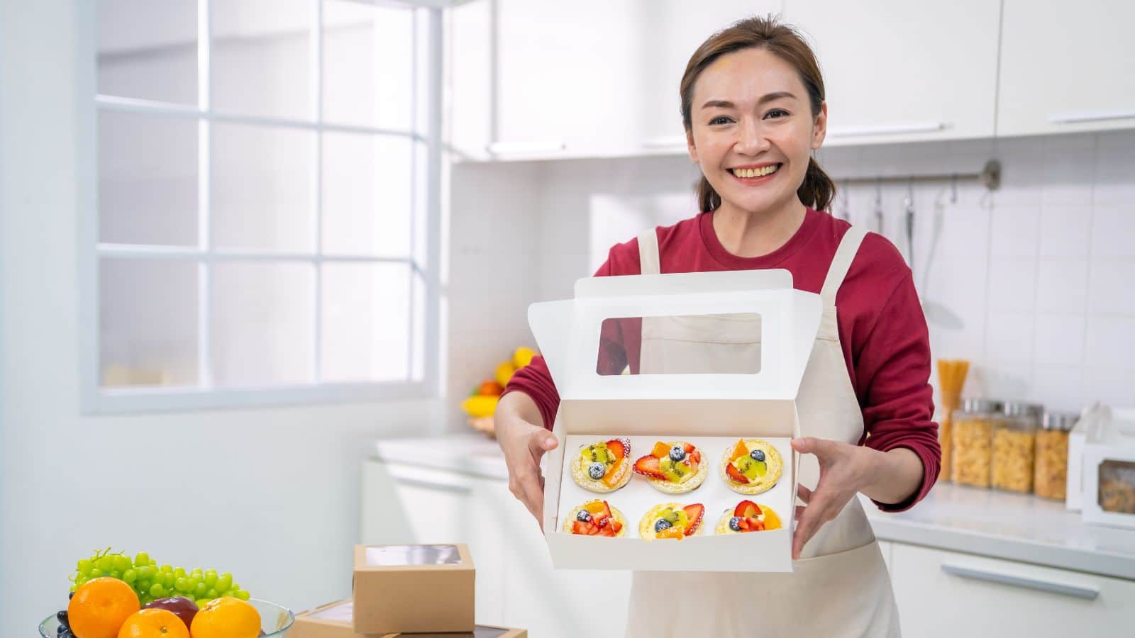 Middle-aged home baker showing off her creations