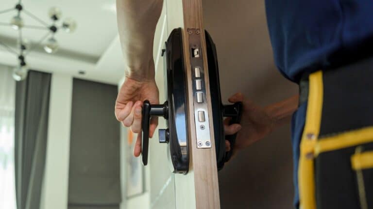 Man changing lock on a door