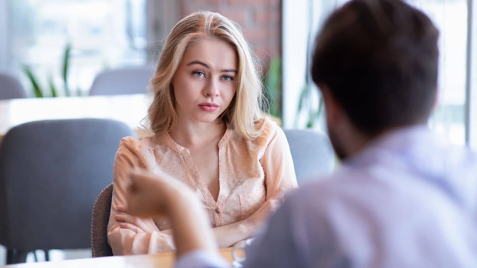 Couple on dinner date with the woman looking annoyed
