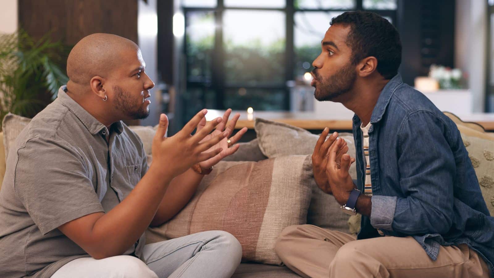 Men sitting on the couch arguing