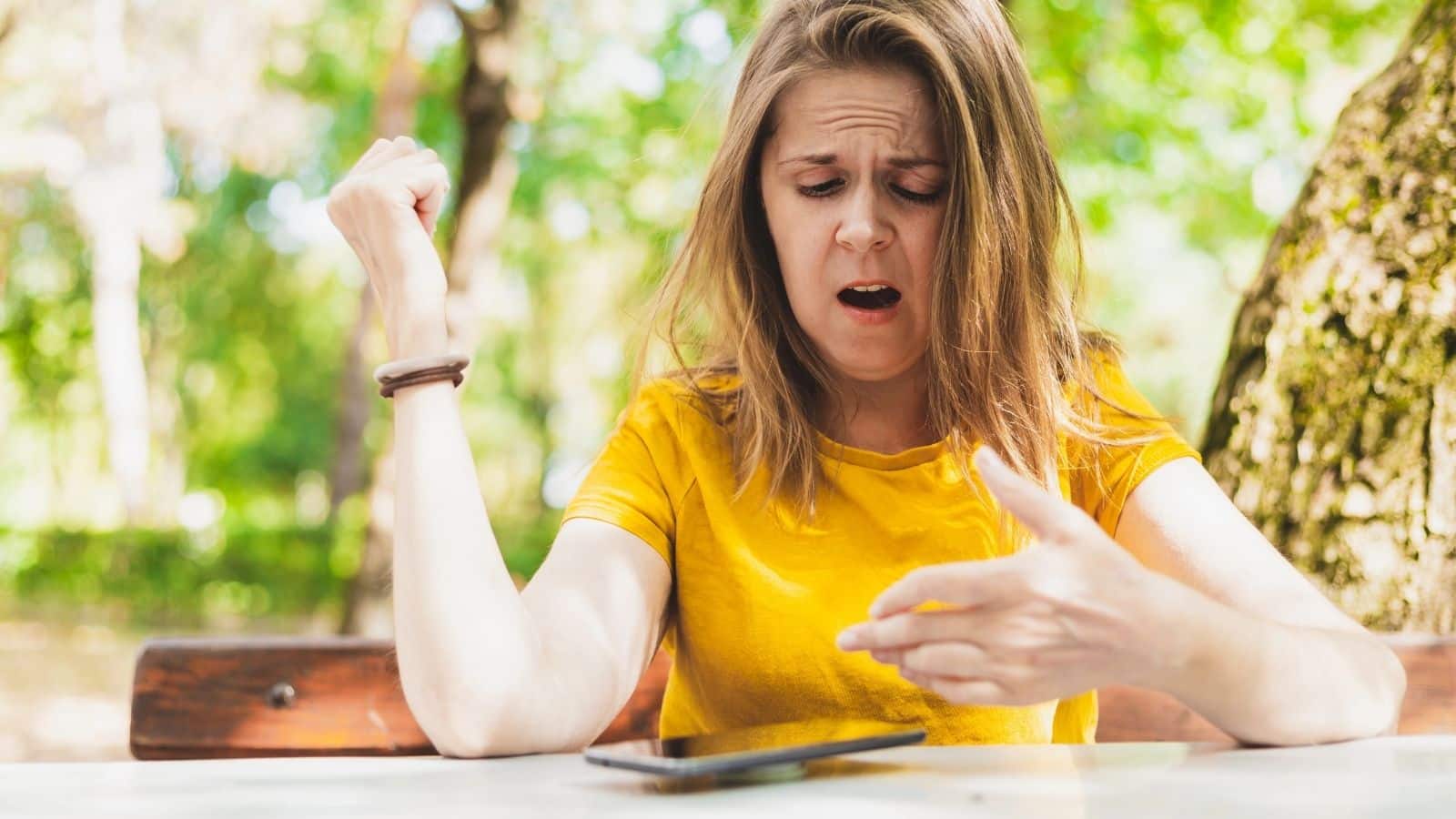 Woman looking upset while looking at her phone
