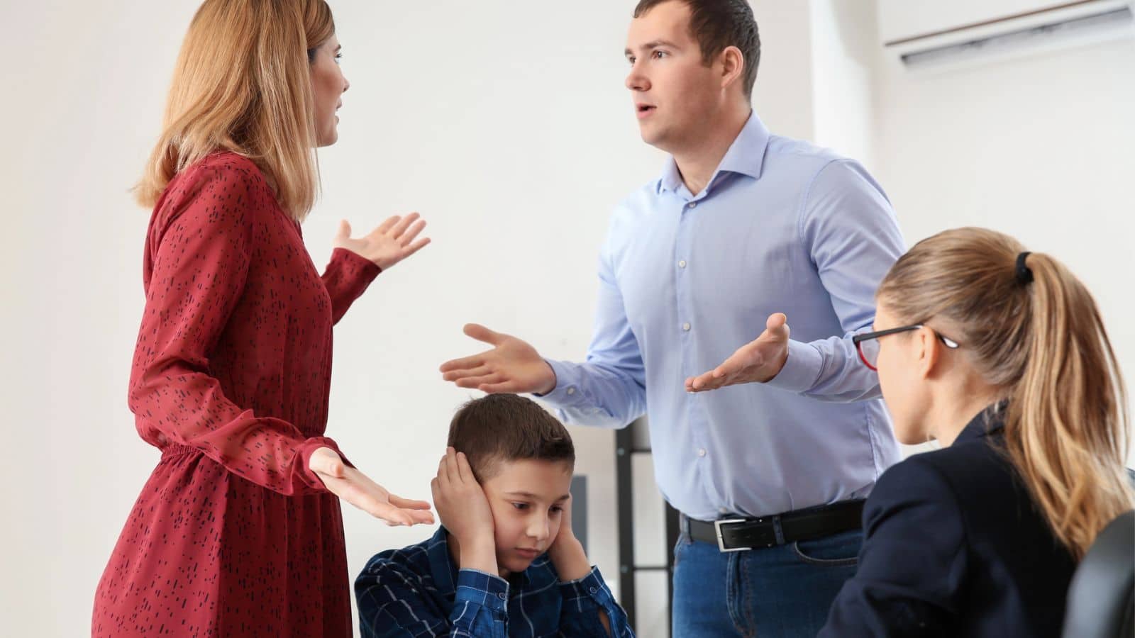 Couple arguing in front of attorney and child