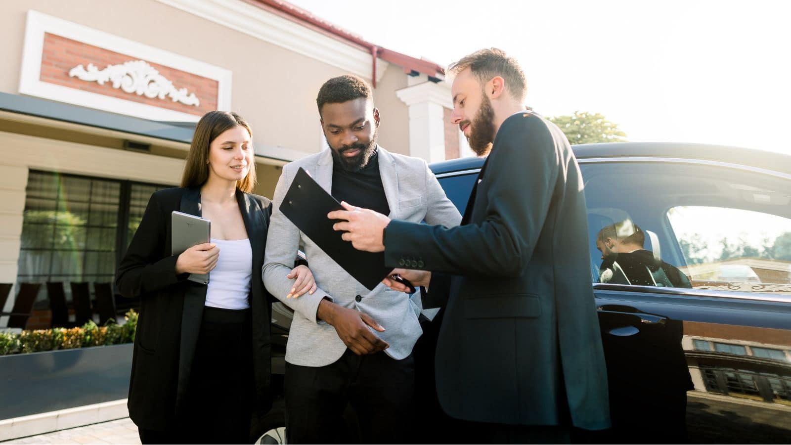Couple signing papers for a vehicle purchase