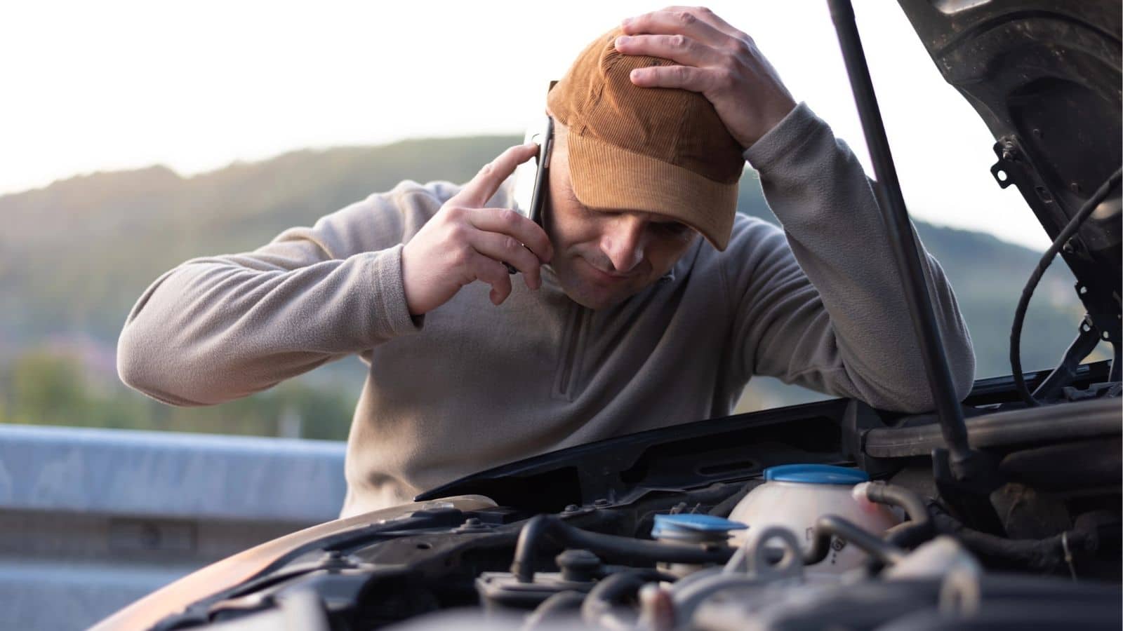 Man having engine problems with popped hood