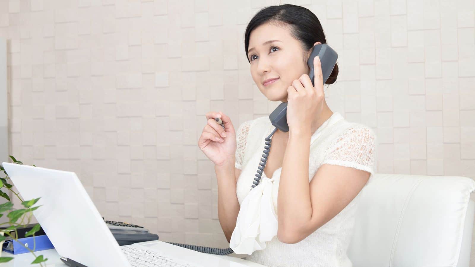 Receptionist smiling while on the phone