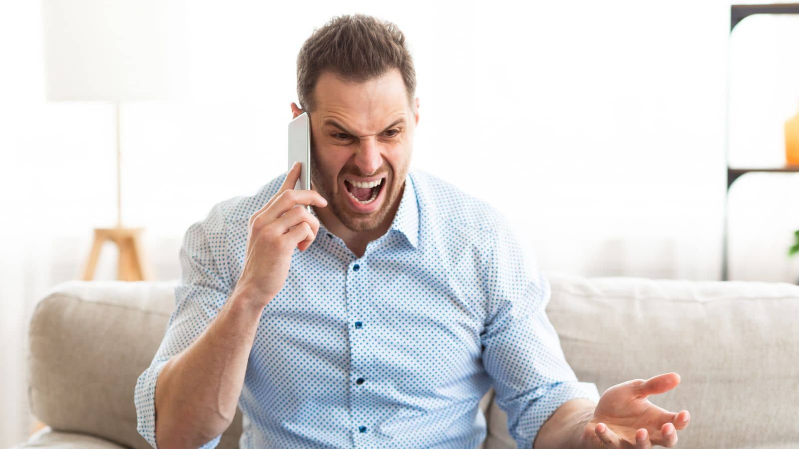 Man talking on the phone looking very angry