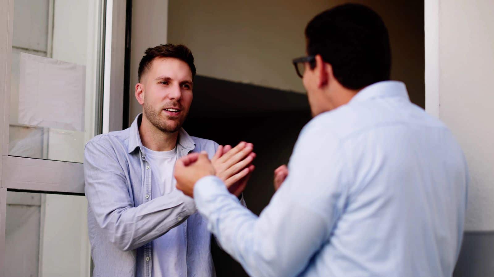 Men arguing in a doorway
